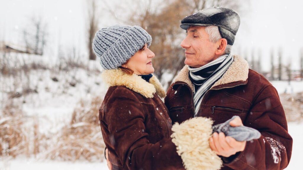 Elderly couple walking together on a winter day at The Heartlands senior living in Marlette, MI.